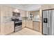 Kitchen featuring stainless steel appliances, light wood cabinets and light blue countertops at 116 Sheridan Ave, Longwood, FL 32750