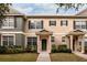 Two-story townhome with neutral siding, landscaping, and a double-door entry at 12557 Langstaff Dr, Windermere, FL 34786