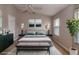 Virtually staged main bedroom with a gray upholstered bed and a neutral color scheme at 12557 Langstaff Dr, Windermere, FL 34786