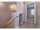 Upstairs hallway with neutral paint, carpeted floors, and access to bedrooms at 12557 Langstaff Dr, Windermere, FL 34786