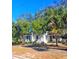 One-story house with a porch and palm trees at 1303 Stowe Ave, Mount Dora, FL 32757