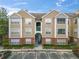 Tan and brick two-story condo building with parking and landscaping at 13103 Mulberry Park Dr # 811, Orlando, FL 32821