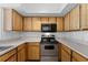 Well-equipped kitchen with wood cabinets and stainless steel appliances at 13103 Mulberry Park Dr # 811, Orlando, FL 32821