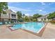 Community pool with lounge chairs and surrounding buildings at 13103 Mulberry Park Dr # 811, Orlando, FL 32821