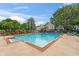 Community pool with lounge chairs and building view at 13103 Mulberry Park Dr # 811, Orlando, FL 32821