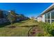 Landscaped backyard with grassy area and trees at 1440 Waterview Ridge Cir, Apopka, FL 32703