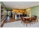 Open concept dining room and kitchen with mid-century modern furniture at 1440 Waterview Ridge Cir, Apopka, FL 32703