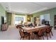 Living room with sliding glass doors leading to backyard, neutral colored sofa and chairs at 1440 Waterview Ridge Cir, Apopka, FL 32703