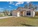 Two-story house with a double-car garage and a small front yard at 1448 Brook Hollow Dr, Orlando, FL 32824