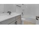 Bathroom with gray vanity, single sink, and bathtub at 15450 Lebeau Loop, Winter Garden, FL 34787