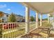 Front porch with white columns and brick flooring at 15450 Lebeau Loop, Winter Garden, FL 34787