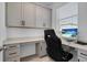 Home office with built-in desk and cabinets, offering ample workspace at 15450 Lebeau Loop, Winter Garden, FL 34787