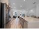 Sleek kitchen island with quartz countertops and a stainless steel fridge at 15450 Lebeau Loop, Winter Garden, FL 34787