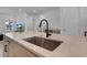 Kitchen island with farmhouse sink and modern black faucet at 15450 Lebeau Loop, Winter Garden, FL 34787