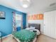 Guest bedroom with a full-size bed and bright, cheerful decor at 165 Williamson Dr, Davenport, FL 33897