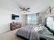 Bright bedroom with a king-size bed, large TV, and ample dresser storage at 165 Williamson Dr, Davenport, FL 33897