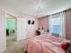 Pink bedroom with a queen bed, desk, and en-suite bathroom at 165 Williamson Dr, Davenport, FL 33897