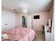 Light pink bedroom with a queen bed and en-suite bathroom at 165 Williamson Dr, Davenport, FL 33897