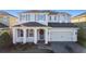 Two-story house with gray siding, gray shutters, and a paved driveway at 165 Williamson Dr, Davenport, FL 33897