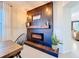 Modern electric fireplace with wood-look surround and mantel at 165 Williamson Dr, Davenport, FL 33897