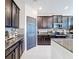 Dark wood cabinets, granite countertops, and stainless steel appliances in this kitchen at 165 Williamson Dr, Davenport, FL 33897