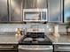 Stainless steel appliances and granite countertops highlight this kitchen at 165 Williamson Dr, Davenport, FL 33897