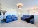 Spacious loft with two blue reclining sofas and a decorative plant at 165 Williamson Dr, Davenport, FL 33897