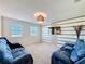 Relaxing loft with two blue reclining sofas and a wood accent wall at 165 Williamson Dr, Davenport, FL 33897