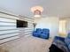 Spacious loft with two sofas and a wood accent wall at 165 Williamson Dr, Davenport, FL 33897