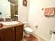 Clean bathroom with shower, toilet, and vanity with wood cabinets at 1708 Clubhouse Cv, Haines City, FL 33844