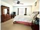 Spacious bedroom with wood dresser and ceiling fan at 1708 Clubhouse Cv, Haines City, FL 33844