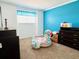 Bedroom with carpeted floor and blue accent wall at 1708 Clubhouse Cv, Haines City, FL 33844