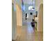 Long hallway with tile flooring offering views to the living areas at 1708 Clubhouse Cv, Haines City, FL 33844