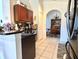 Kitchen with a breakfast bar, dark wood cabinets and granite countertops at 1708 Clubhouse Cv, Haines City, FL 33844