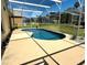 Inviting kidney-shaped pool with screened enclosure at 1708 Clubhouse Cv, Haines City, FL 33844