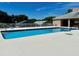 Inviting community pool with lounge chairs and a clear blue surface at 1708 Clubhouse Cv, Haines City, FL 33844