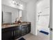 Double-sink bathroom with granite countertop and a bathtub at 1713 Fullers Oak Loop, Winter Garden, FL 34787