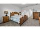 Cozy bedroom with wooden furniture and carpeted floor at 1713 Fullers Oak Loop, Winter Garden, FL 34787