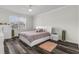 Bright bedroom with a queen bed and hardwood floors at 1713 Fullers Oak Loop, Winter Garden, FL 34787