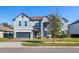 Two-story house with gray exterior, landscaping, and a two-car garage at 1713 Fullers Oak Loop, Winter Garden, FL 34787