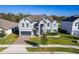 Two-story house with gray exterior, landscaping, and a two-car garage at 1713 Fullers Oak Loop, Winter Garden, FL 34787