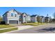 Houses on a street with lawns and sidewalks; one is gray and two stories at 1713 Fullers Oak Loop, Winter Garden, FL 34787