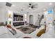 Living room with white sectional sofa, fireplace and hardwood floors at 1713 Fullers Oak Loop, Winter Garden, FL 34787