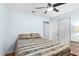 Bedroom with double bed, ceiling fan, and double door closet at 1820 Putney Cir, Orlando, FL 32837