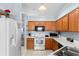 Kitchen with light wood cabinets, white appliances, and a breakfast bar at 1820 Putney Cir, Orlando, FL 32837