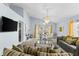 Open concept living and dining area with gray sofas and glass dining table at 1820 Putney Cir, Orlando, FL 32837