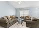 Living room with two brown sofas and a glass coffee table at 1820 Putney Cir, Orlando, FL 32837