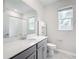 Bathroom with vanity, toilet, shower, and window at 1870 Dumbleton Pl, St Cloud, FL 34771