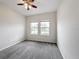 Bedroom with two windows and ceiling fan at 1870 Dumbleton Pl, St Cloud, FL 34771