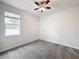 Bright bedroom with ceiling fan, window, and carpet at 1870 Dumbleton Pl, St Cloud, FL 34771